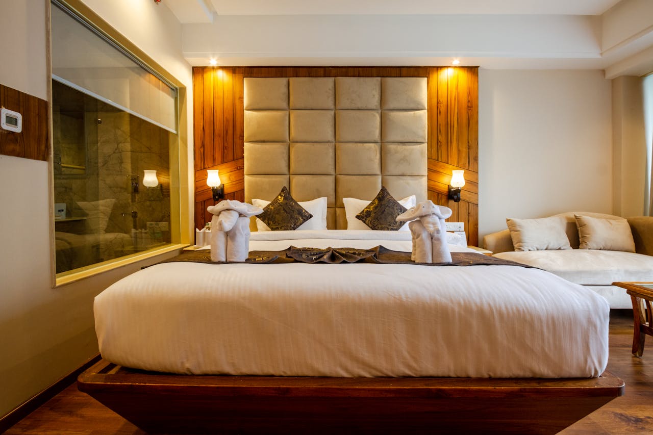 Elegant hotel bedroom with a stylish double bed and luxurious interior design elements.