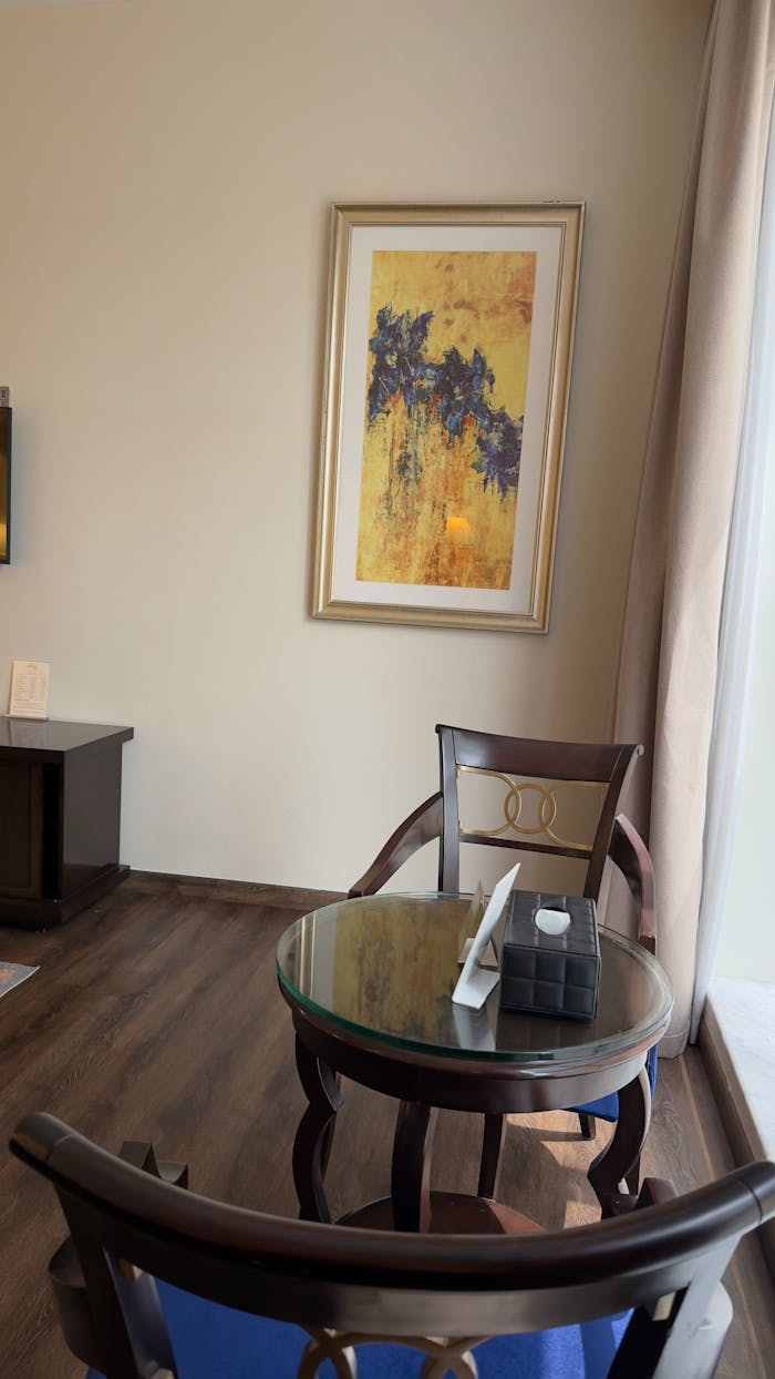 Mastering the First Impression: Your intriguing post title goes here A cozy corner with chairs and art in a modern room, offering warm tones.